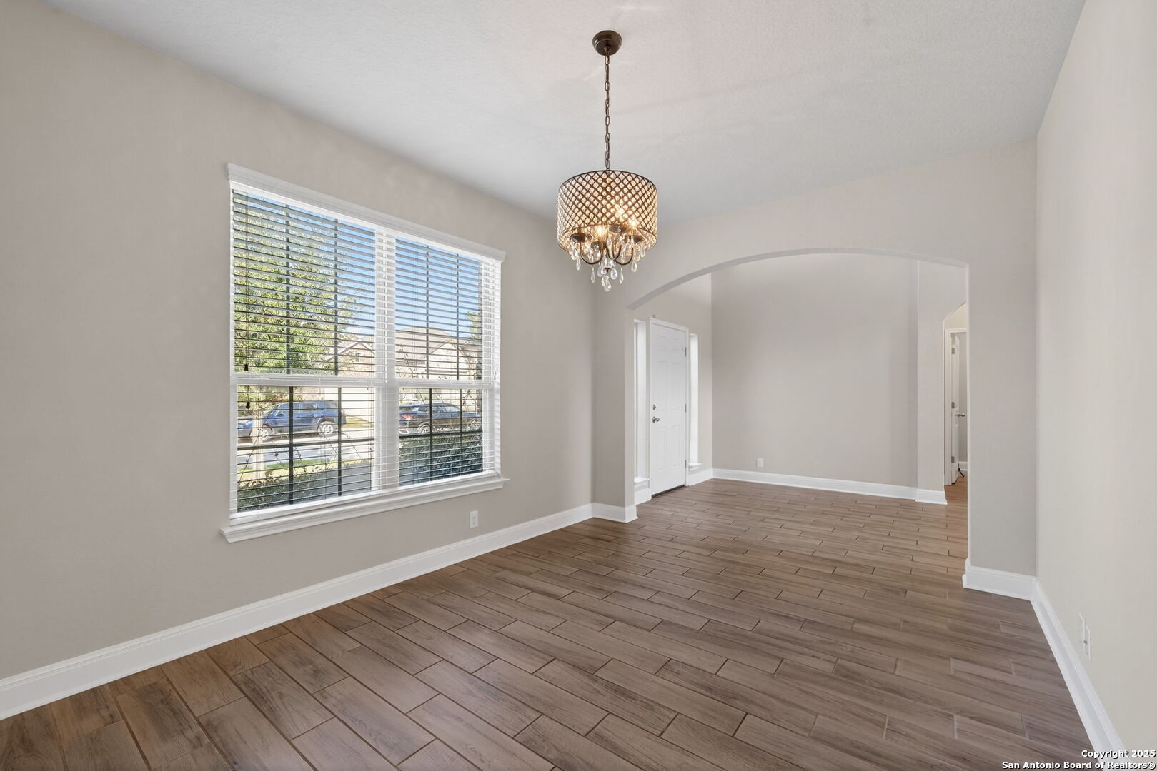 8326 Hydrangea Path Boerne, TX 78015 - Photo 15 of 39 a view of an empty room with wooden floor and a window