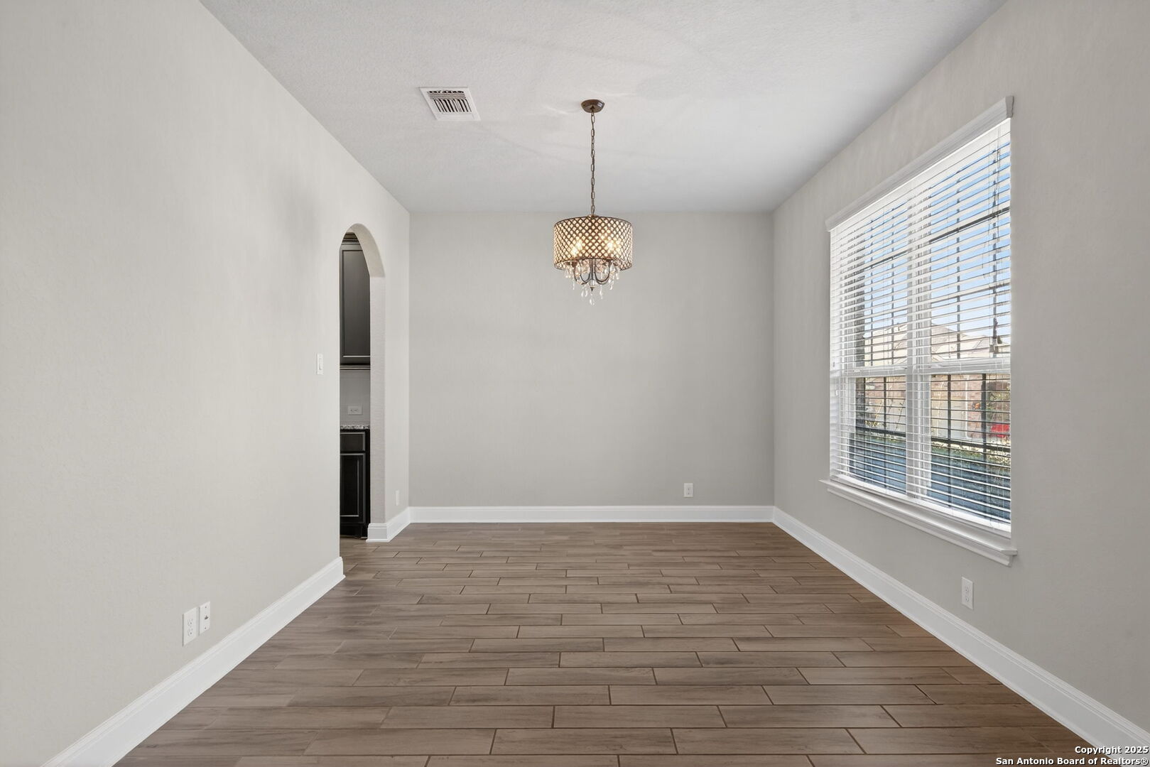 8326 Hydrangea Path Boerne, TX 78015 - Photo 16 of 39 a view of an empty room with wooden floor and a window