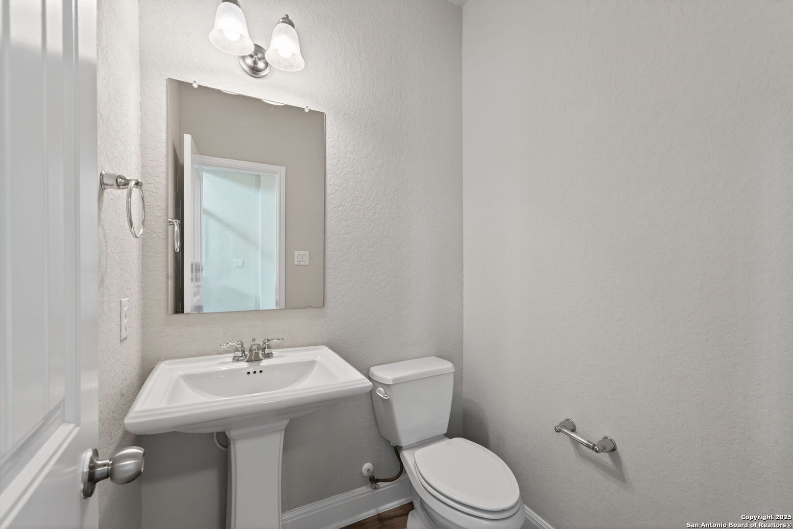 8326 Hydrangea Path Boerne, TX 78015 - Photo 17 of 39 a bathroom with a sink toilet and mirror