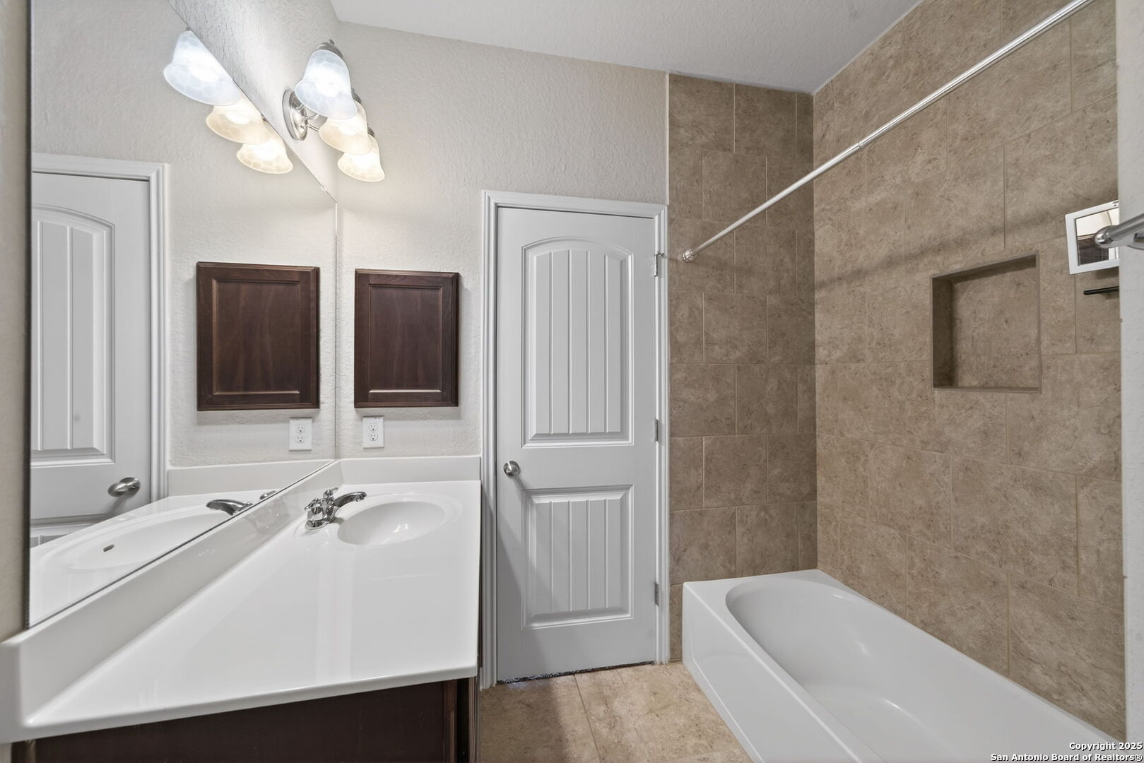 8326 Hydrangea Path Boerne, TX 78015 - Photo 26 of 39 a bathroom with a tub sink and mirror