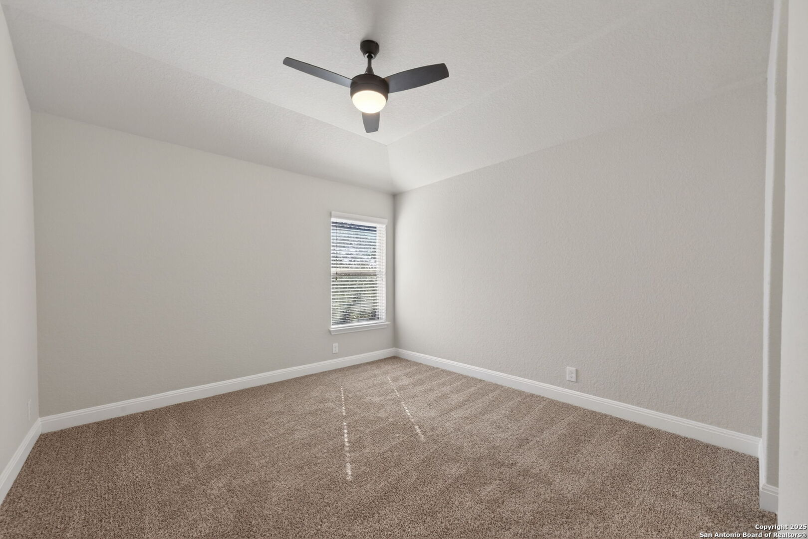 8326 Hydrangea Path Boerne, TX 78015 - Photo 27 of 39 an empty room with a window and a fan