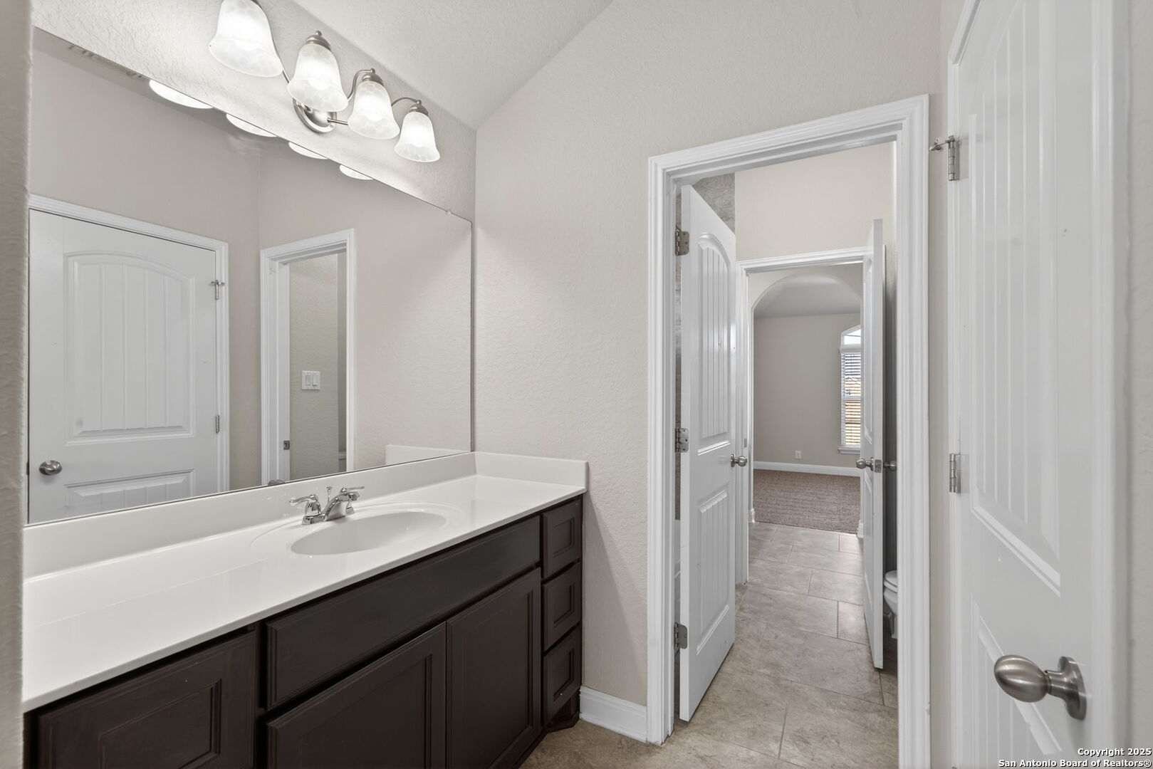 8326 Hydrangea Path Boerne, TX 78015 - Photo 28 of 39 a bathroom with a double vanity sink a mirror and a shower