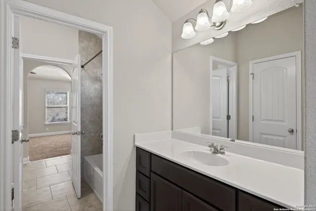 a bathroom with a double vanity sink mirror and shower