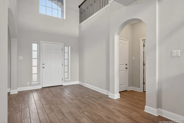 an empty room with wooden floor and closet