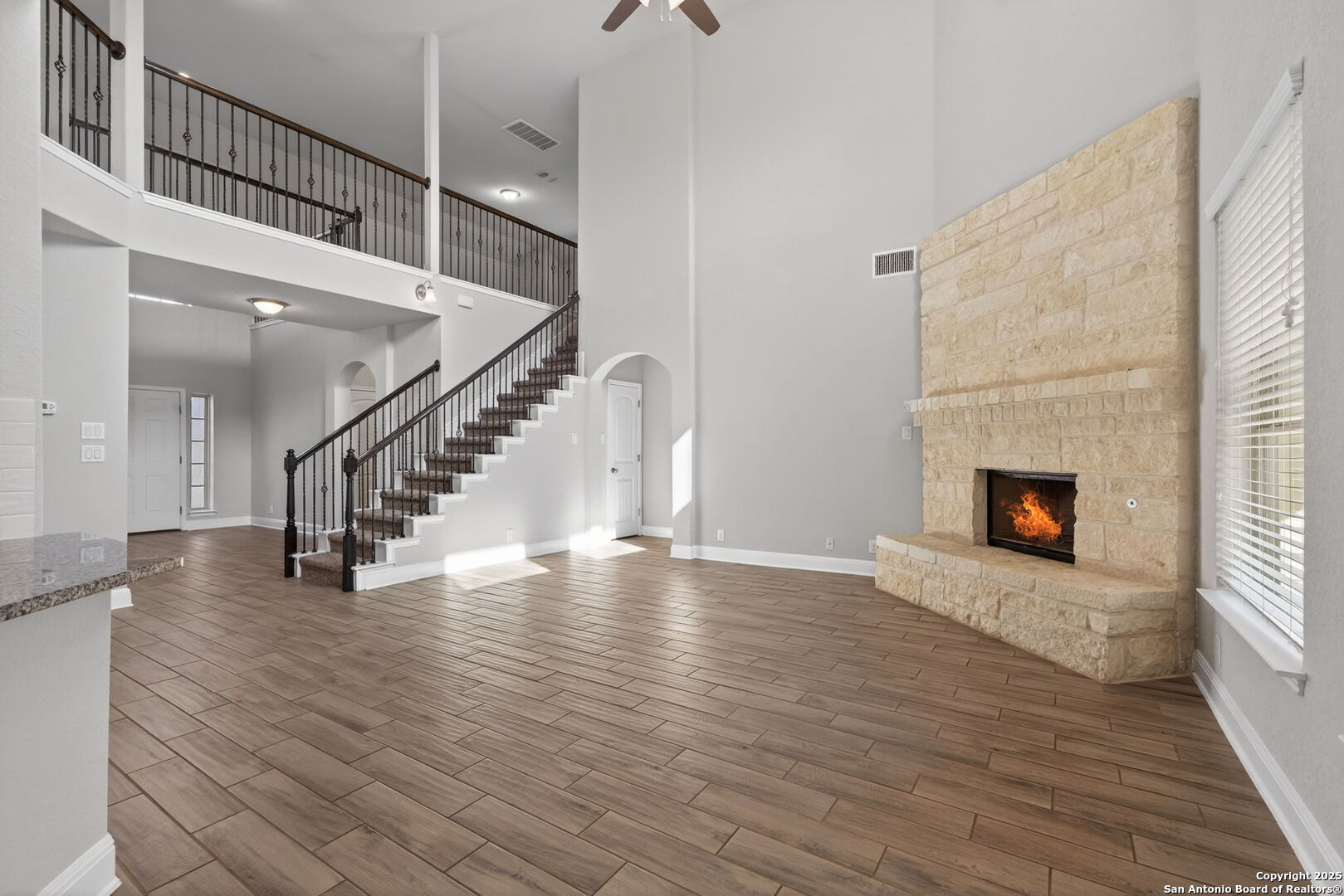 8326 Hydrangea Path Boerne, TX 78015 - Photo 6 of 39 a view of a livingroom with wooden floor and a fireplace