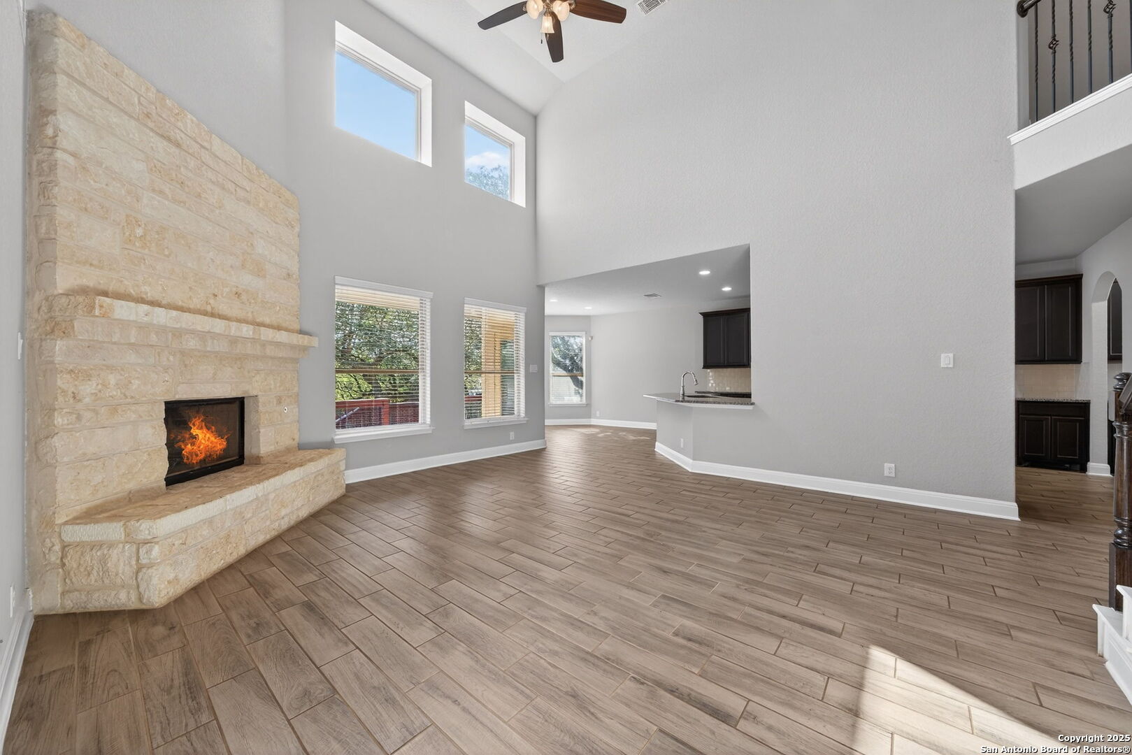 8326 Hydrangea Path Boerne, TX 78015 - Photo 7 of 39 a view of an empty room with wooden floor and a fireplace