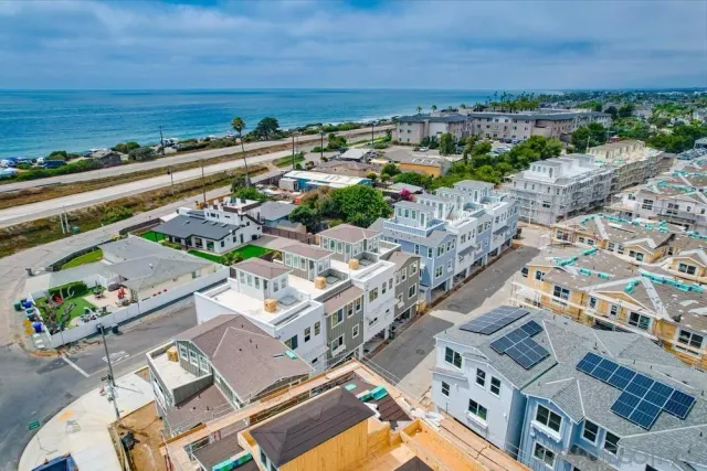 an aerial view of a city and ocean view