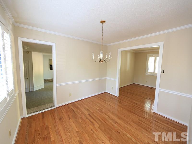 1504 Stratlen Court Raleigh, NC 27615 - Photo 8 of 17 a view of an empty room with wooden floor and a window