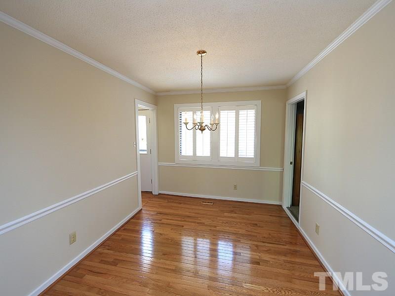 1504 Stratlen Court Raleigh, NC 27615 - Photo 9 of 17 a view of an empty room with wooden floor and a window