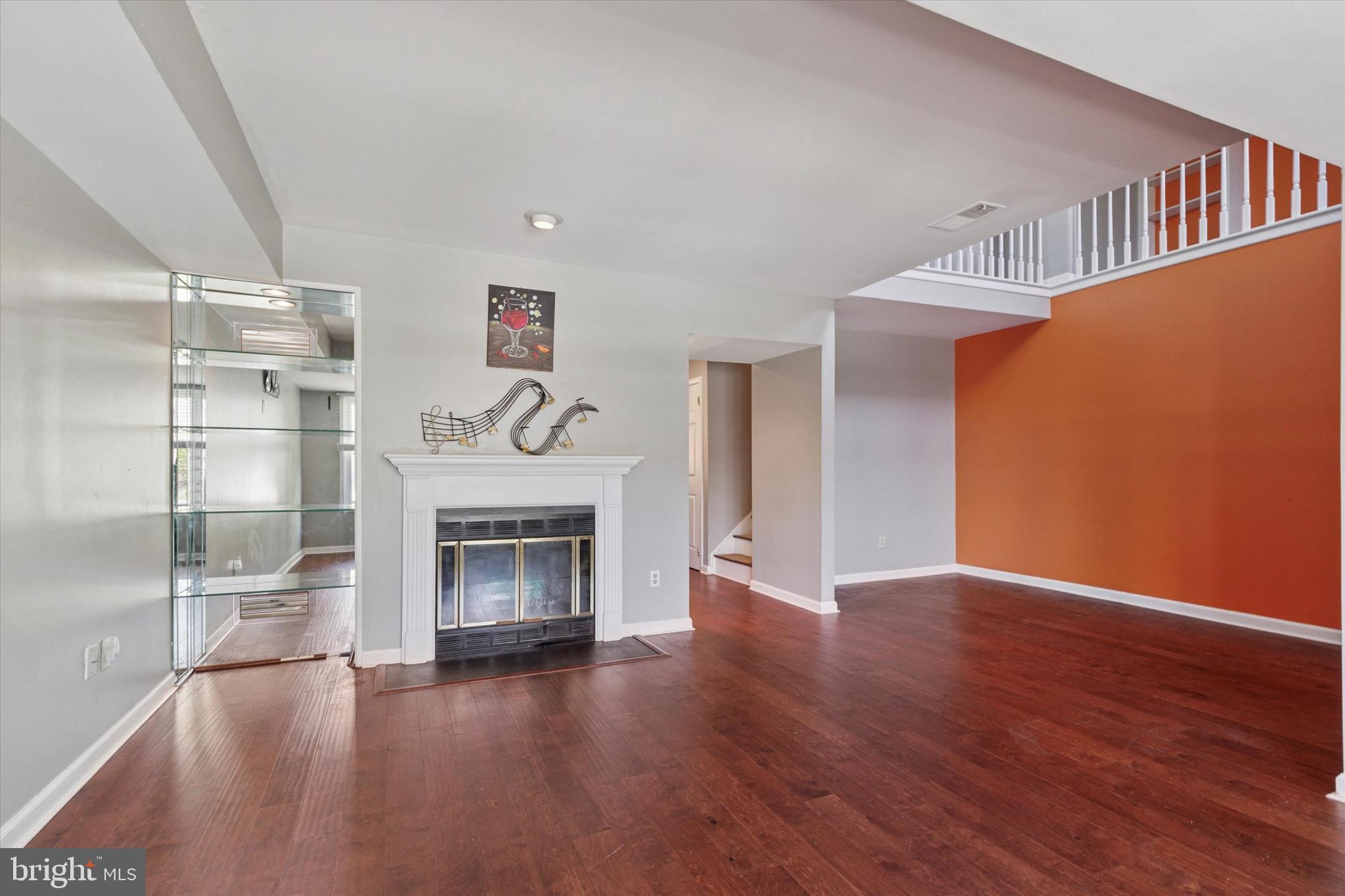 11 Ingham Way New Hope, PA 18938 - Photo 3 of 15 a living room with wooden floors and a fireplace
