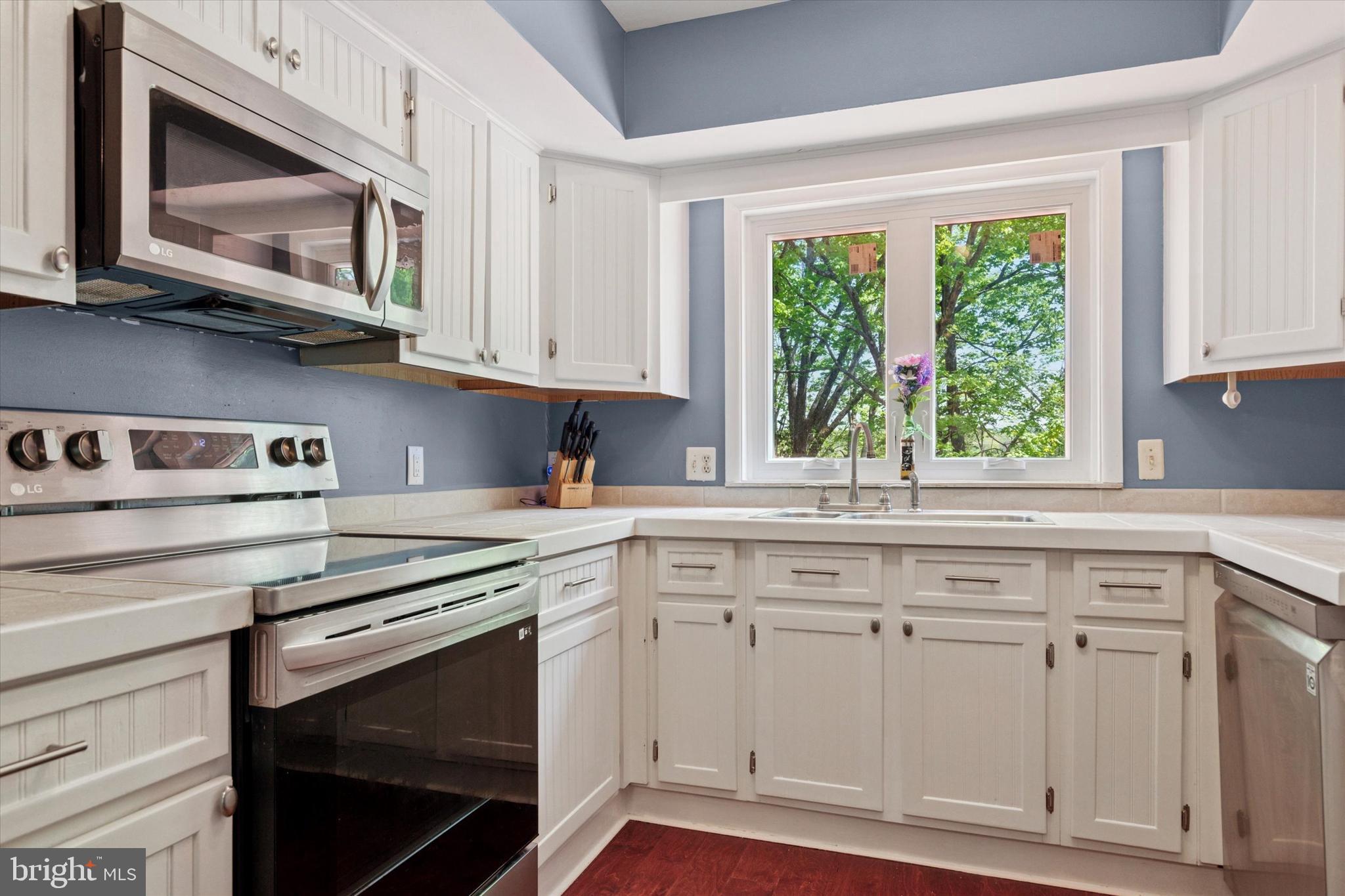 11 Ingham Way New Hope, PA 18938 - Photo 5 of 15 a kitchen with white cabinets appliances and a window