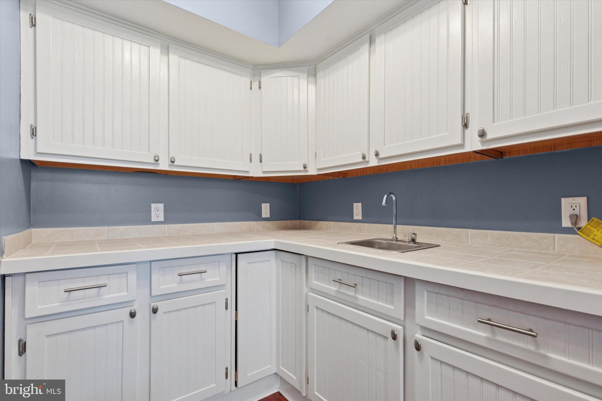 11 Ingham Way New Hope, PA 18938 - Photo 6 of 15 a kitchen with white cabinets and a sink