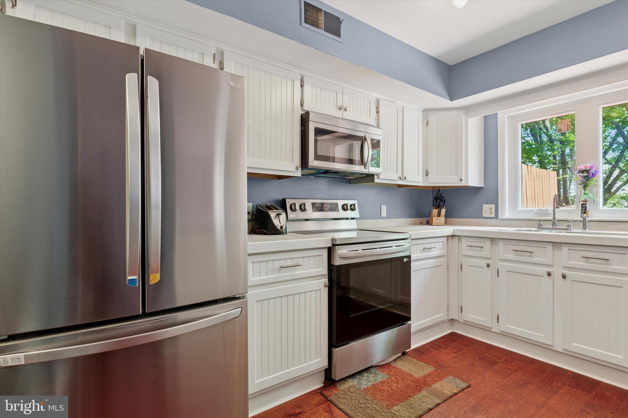 11 Ingham Way New Hope, PA 18938 - Photo 7 of 15 a kitchen with stainless steel appliances white cabinets and a refrigerator