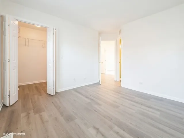 a view of an empty room and wooden floor