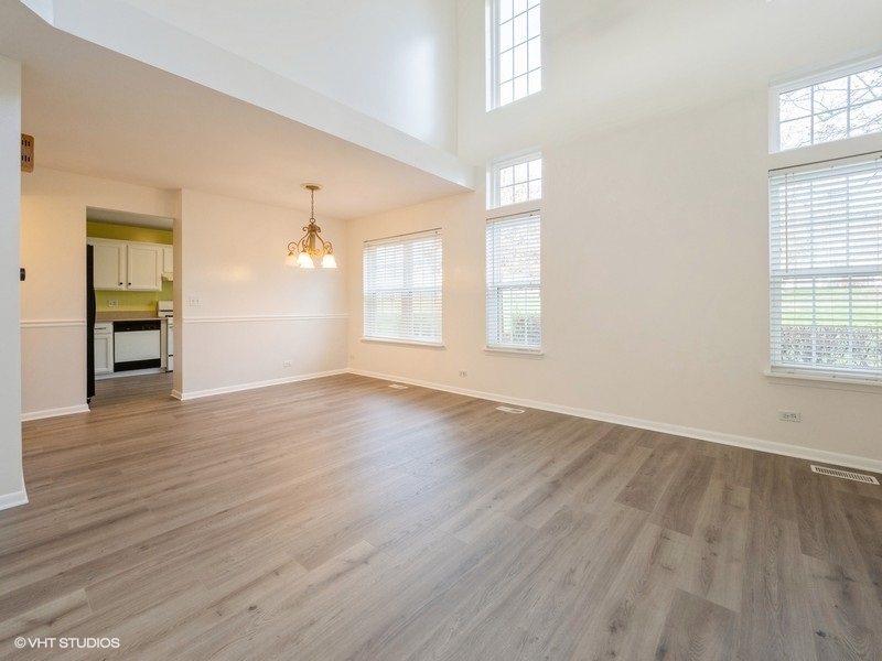 140 Crescent Lane Schaumburg, IL 60193 - Photo 3 of 21 an empty room with wooden floor and windows