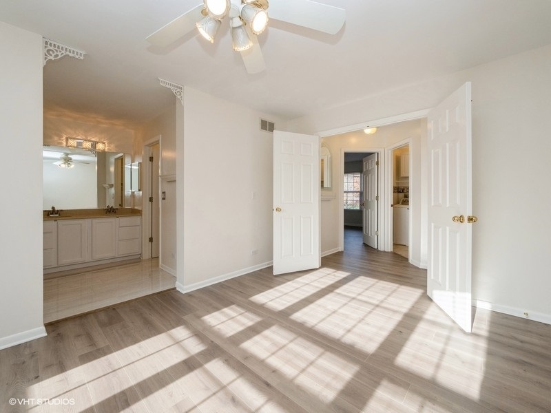 140 Crescent Lane Schaumburg, IL 60193 - Photo 6 of 21 a view of a big room with wooden floor and a kitchen