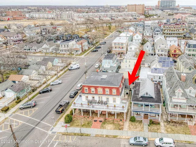 a living room with furniture a flat screen tv and kitchen view