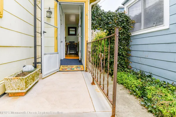 a view of a patio with table and chairs under an umbrella