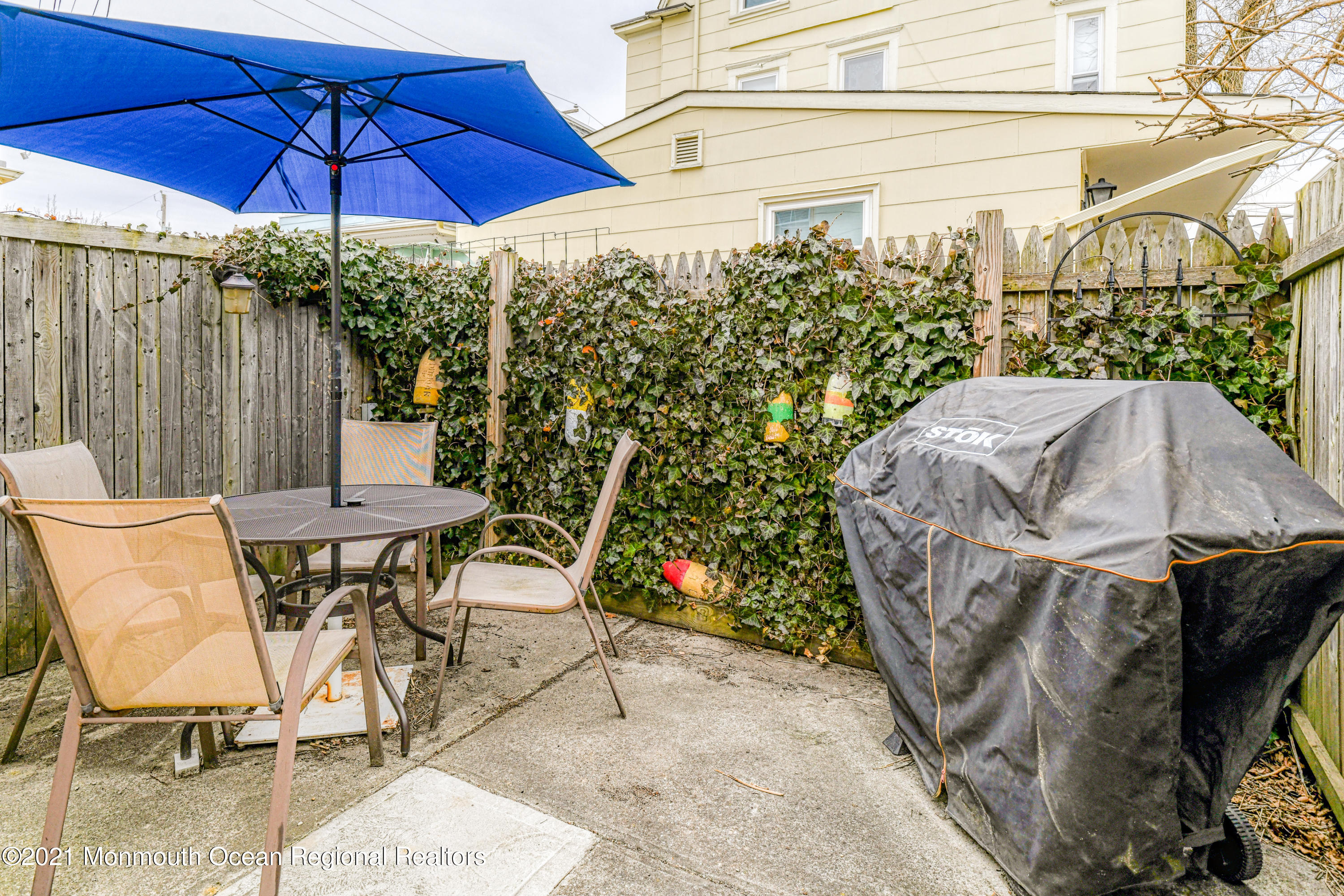 35 Ocean Pathway, Unit 4 Ocean Grove, NJ 07756 - Photo 14 of 15 a view of a patio with table and chairs under an umbrella