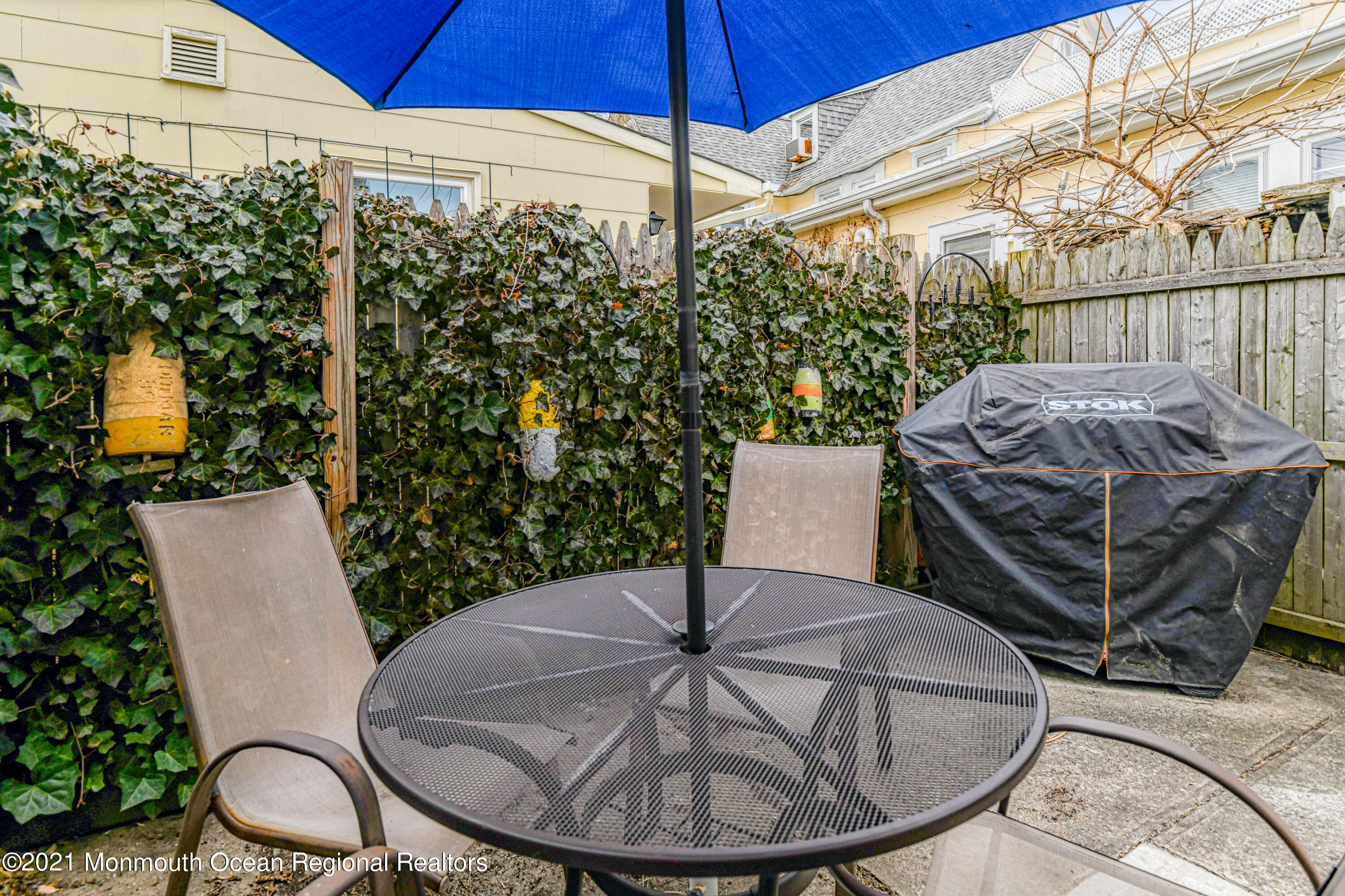 35 Ocean Pathway, Unit 4 Ocean Grove, NJ 07756 - Photo 15 of 15 a backyard of a house with table and chairs