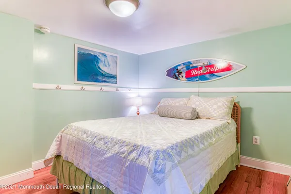 a bedroom with a bed and a painting on the wall