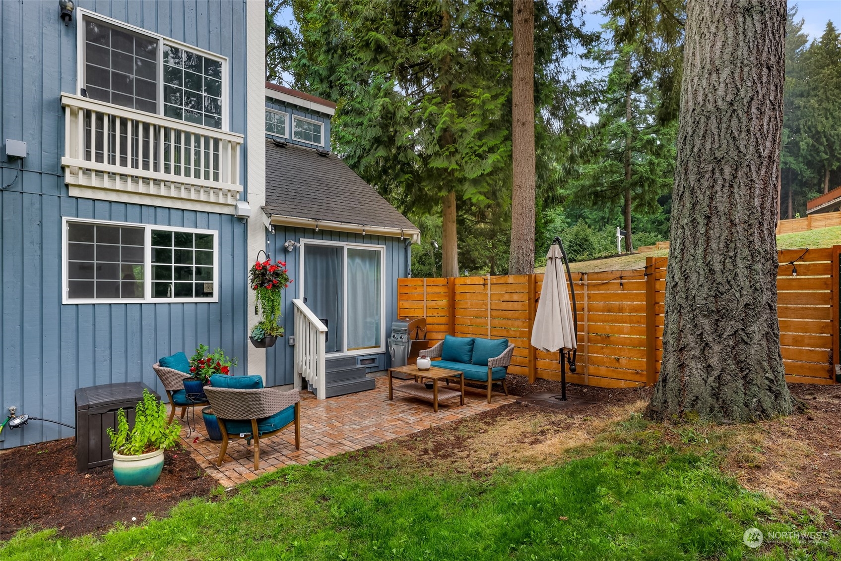 21923 4th Avenue Southeast Bothell, WA 98021 - Photo 23 of 25 a view of backyard with table and chairs and a large tree