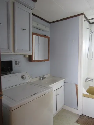 a bathroom with a toilet and a bathtub