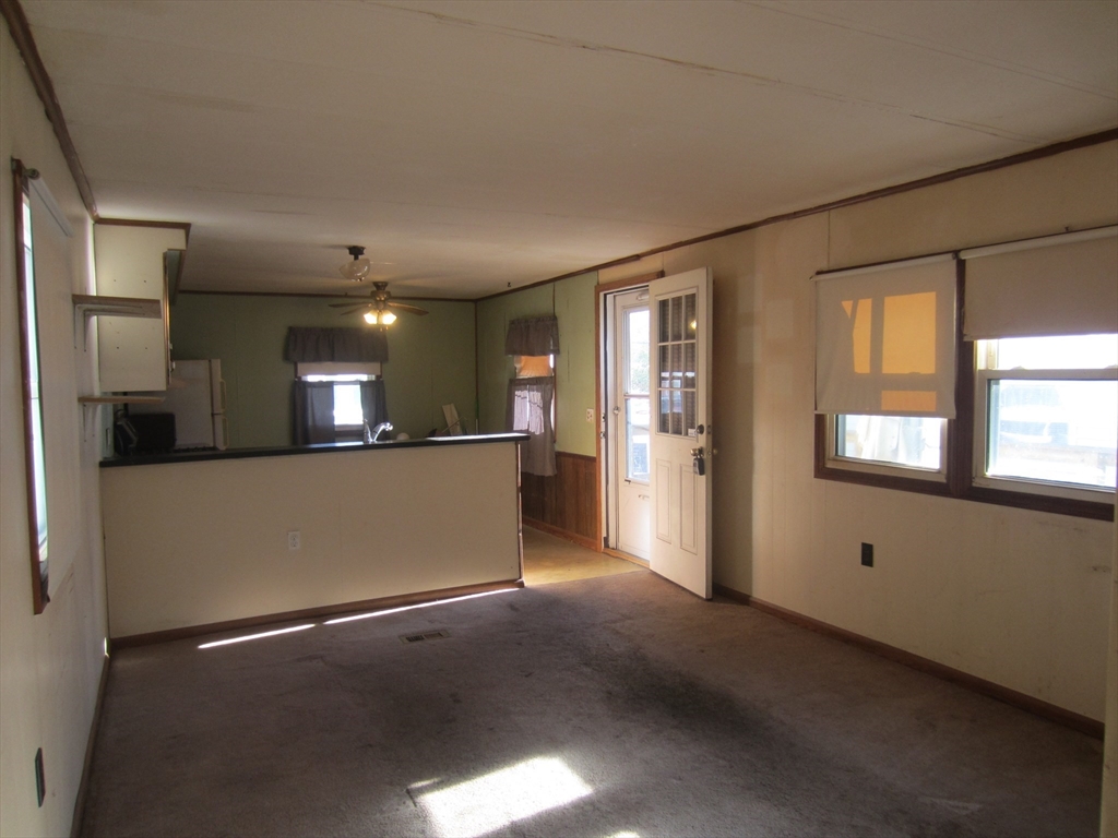 3040 Cranberry Highway, Unit 10 Wareham, MA 02538 - Photo 9 of 22 a view of an empty room with a kitchen