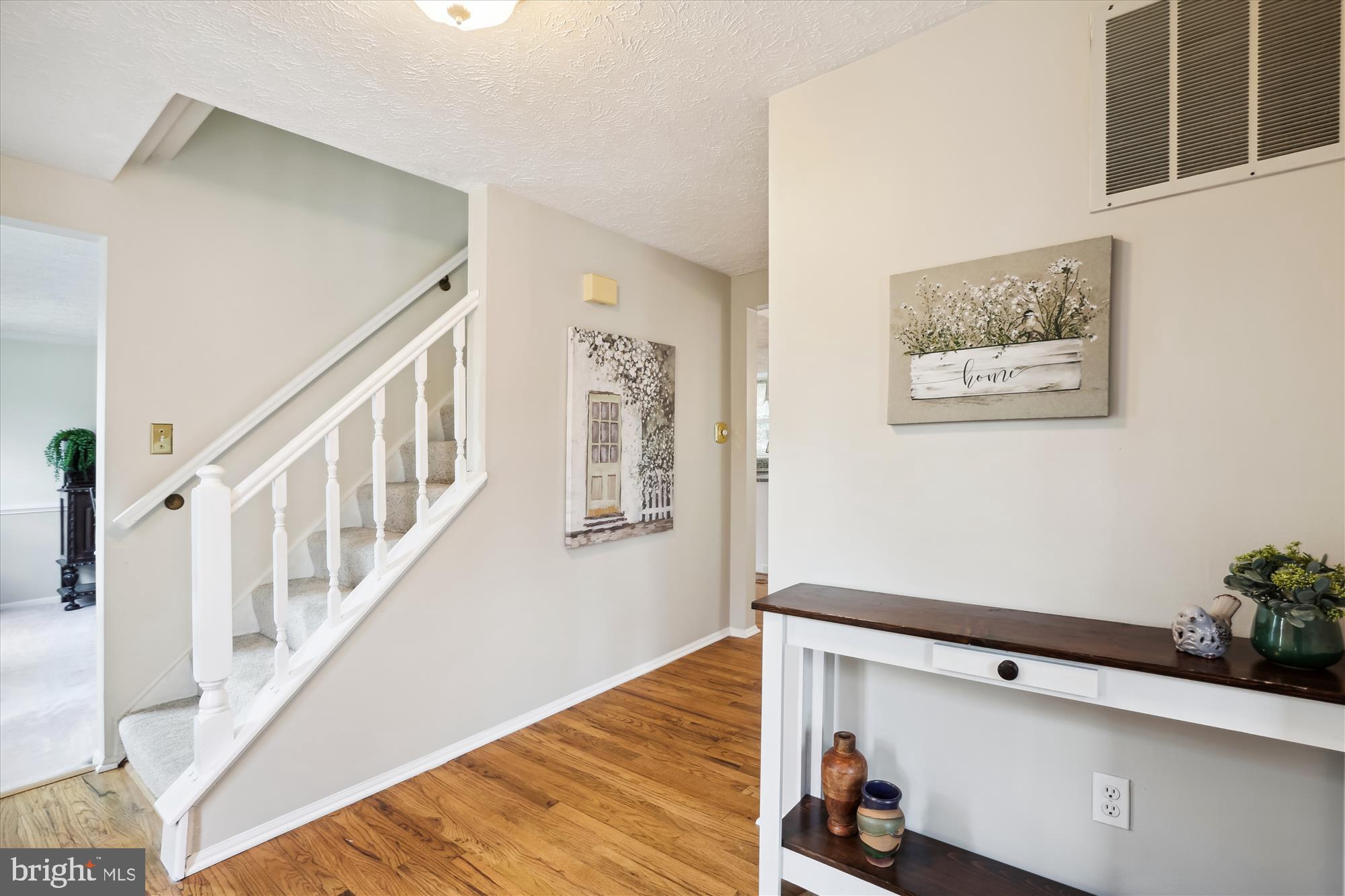 4598 Rincon Place Dumfries, VA 22025 - Photo 2 of 41 You're welcomed inside by warm hardwood floors