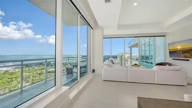 a room with furniture and floor to ceiling windows