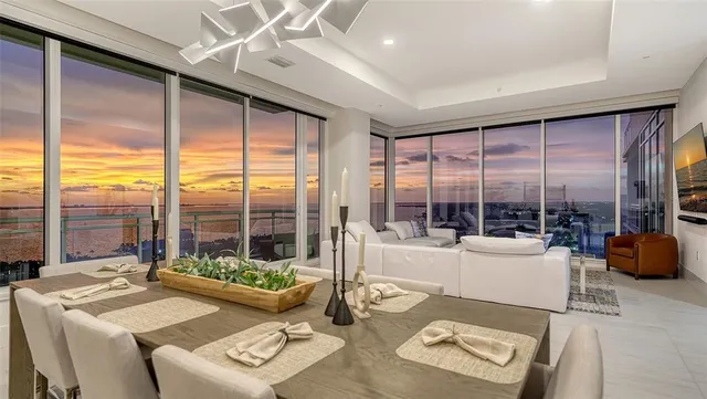 a view of a balcony with chairs and city view