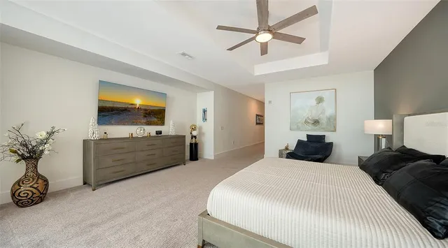 a view of a swimming pool with couches and lounge chair