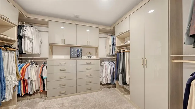a kitchen with a dining table chairs and wooden floor