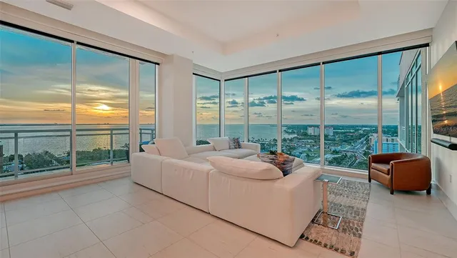a living room with couch and a large window