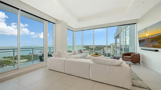 a living room with furniture and a large window