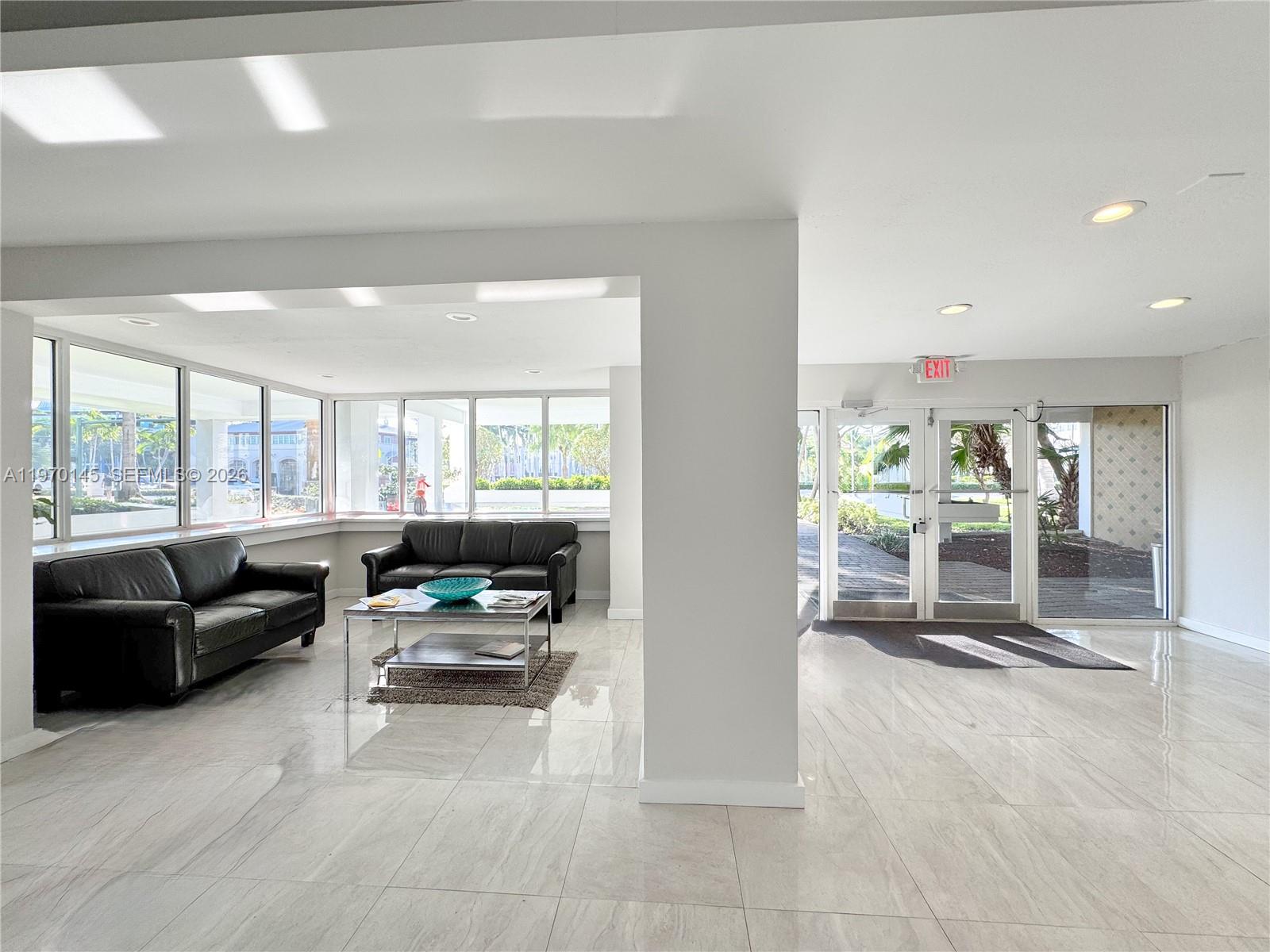 555 Crandon Boulevard, Unit 82 Key Biscayne, FL 33149 - Photo 20 of 28 a living room with furniture and a large window
