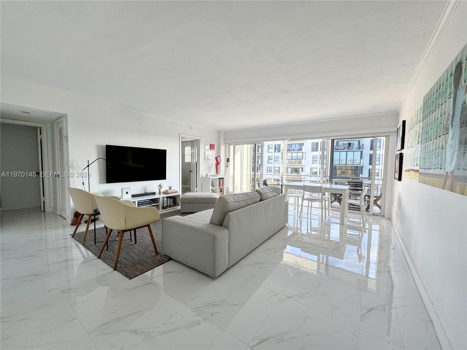 555 Crandon Boulevard, Unit 82 Key Biscayne, FL 33149 - Photo 2 of 28 a living room with furniture and a flat screen tv