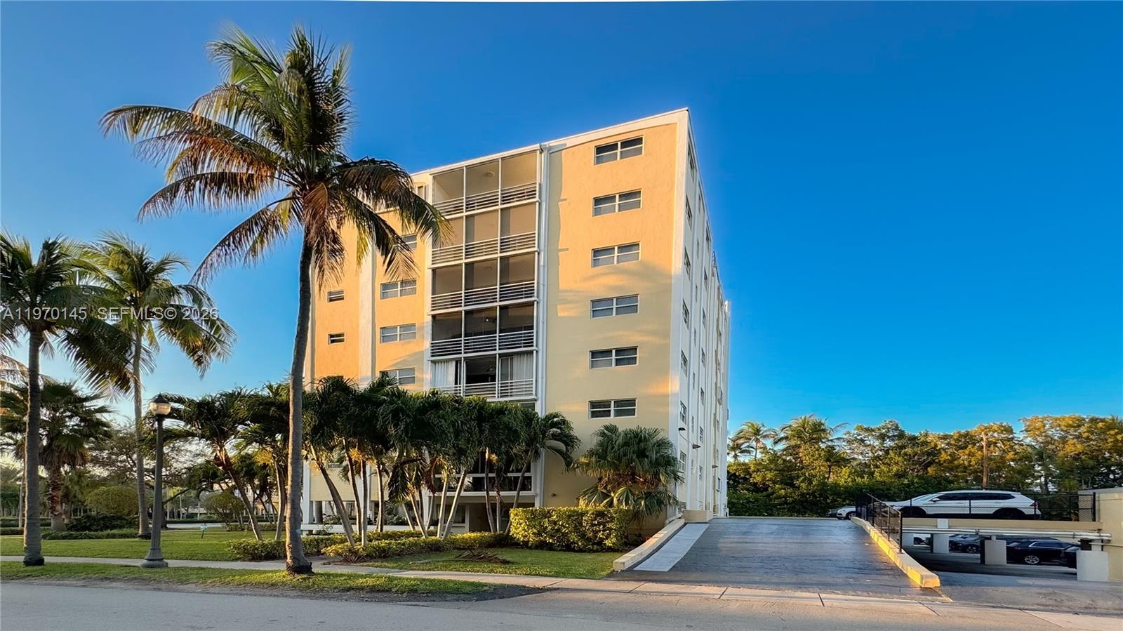 555 Crandon Boulevard, Unit 82 Key Biscayne, FL 33149 - Photo 26 of 28 a palm tree sitting in front of a building