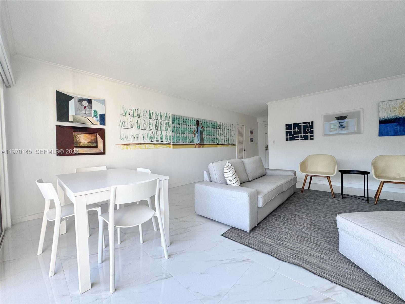 555 Crandon Boulevard, Unit 82 Key Biscayne, FL 33149 - Photo 4 of 28 a living room with furniture and a painting on the wall