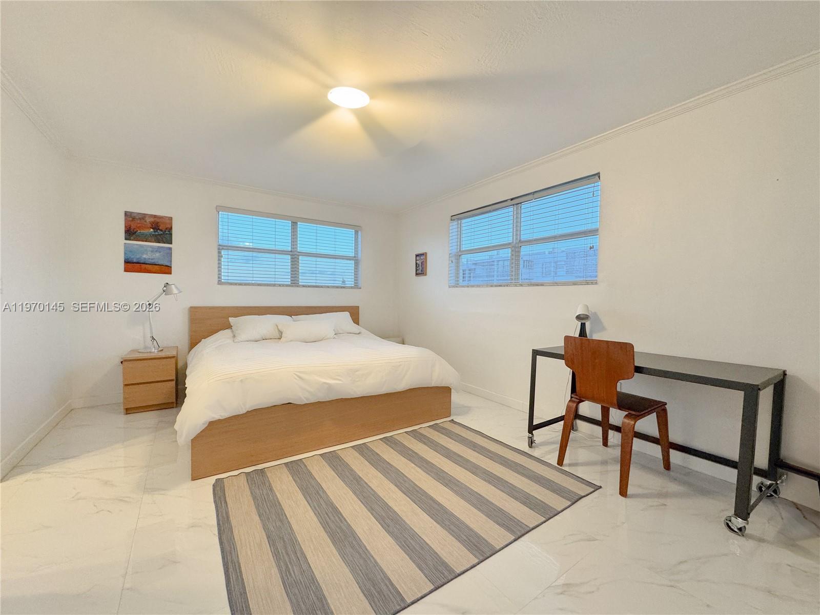 555 Crandon Boulevard, Unit 82 Key Biscayne, FL 33149 - Photo 5 of 28 a bedroom with a bed a chair and potted plant on the dresser