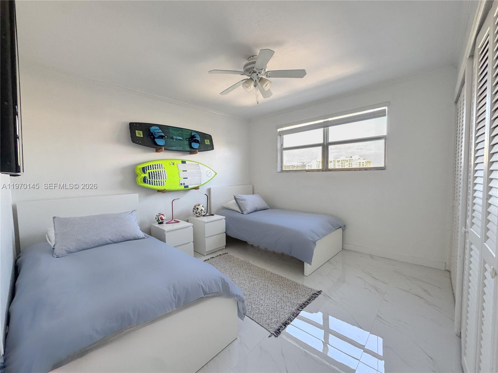 555 Crandon Boulevard, Unit 82 Key Biscayne, FL 33149 - Photo 6 of 28 a bedroom with bed and window