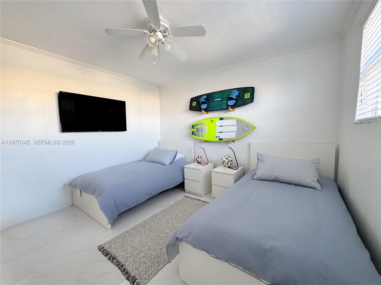 555 Crandon Boulevard, Unit 82 Key Biscayne, FL 33149 - Photo 7 of 28 a living room with furniture and a flat screen tv