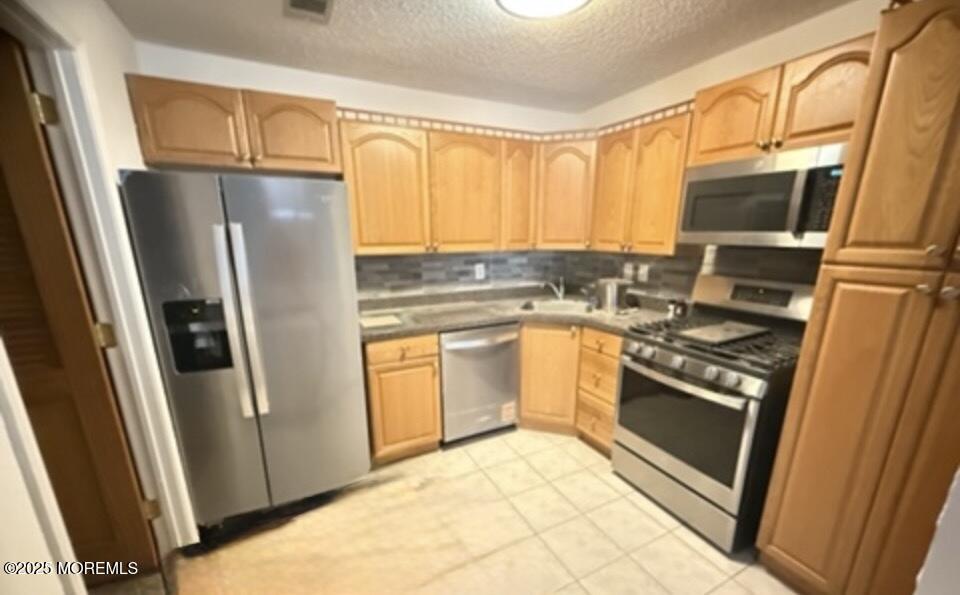 17-7 Augusta Court Freehold, NJ 07728 - Photo 2 of 6 a kitchen with granite countertop a refrigerator stove and sink