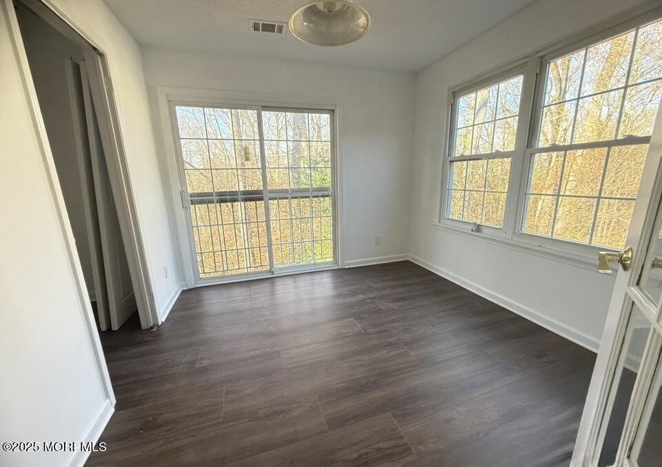 17-7 Augusta Court Freehold, NJ 07728 - Photo 3 of 6 a view of an empty room with wooden floor and a window