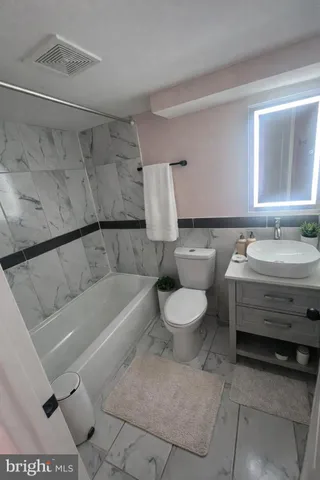 a bathroom with a toilet sink and bathtub