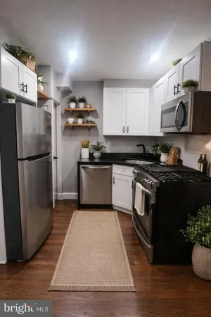 a kitchen with a refrigerator stove top oven and cabinets