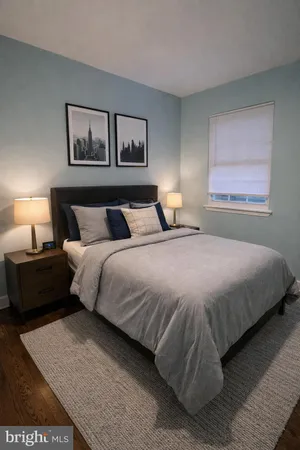 a bedroom with a bed and a painting on the wall