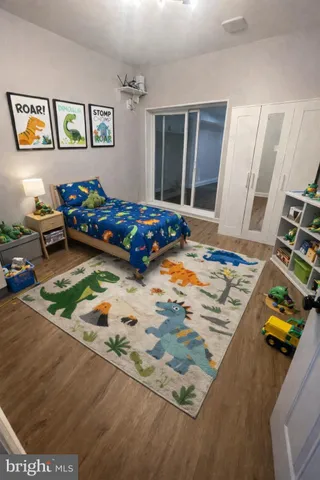 a bed sitting in a bedroom next to a window