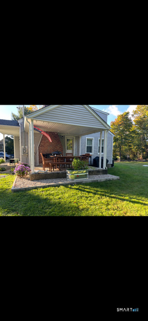 40 Mt Pleasant Road Newtown, CT 06470 - Photo 2 of 23 a view of a swimming pool with an outdoor space and seating