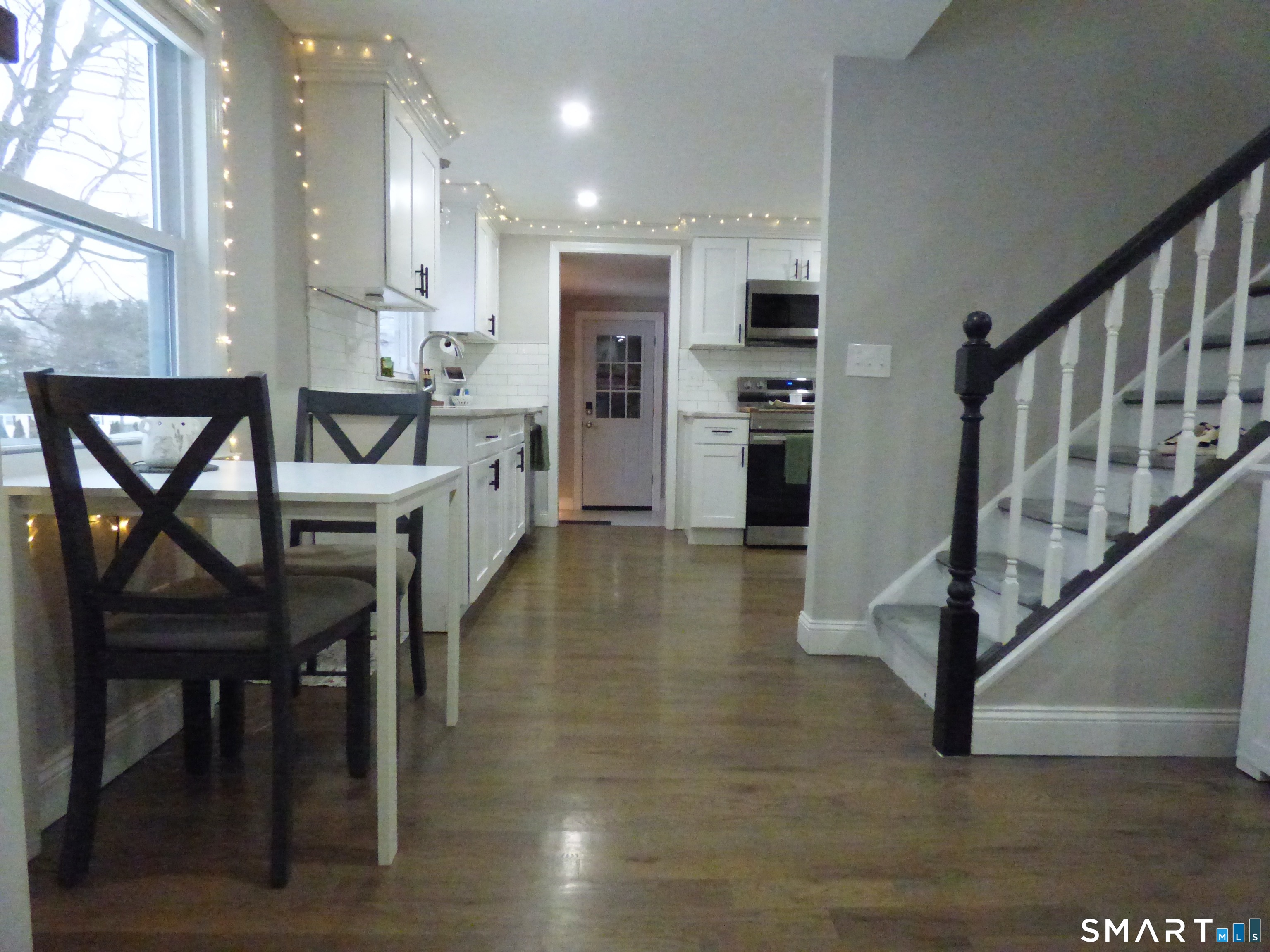 40 Mt Pleasant Road Newtown, CT 06470 - Photo 8 of 23 a kitchen with kitchen island a dining table chairs and a refrigerator